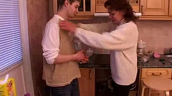 Mature mom and young guy on the kitchen