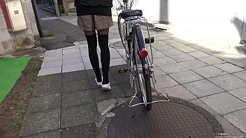 Woman riding a bicycle stepping on the heel of shoes